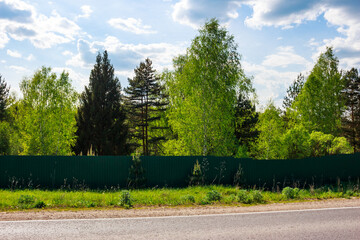 Solid fence closing the passage to the forest