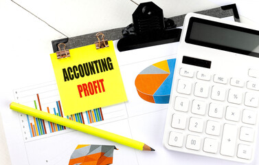 Accounting profit note on clipboard with financial charts, calculator and pencil on white office desk