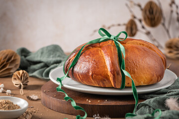 Portuguese traditional Easter cake Folar without eggs on easter table with a green ribbon and small bowl of fennel seeds