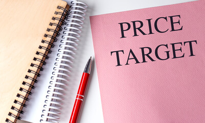 Price target text on pink paper with spiral notebooks and red pen on white background