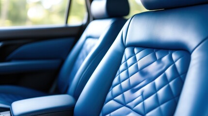 A close-up view of plush blue leather seats in a modern car, exuding luxury and comfort, reflects high-quality craftsmanship and the elegance of contemporary automotive design.