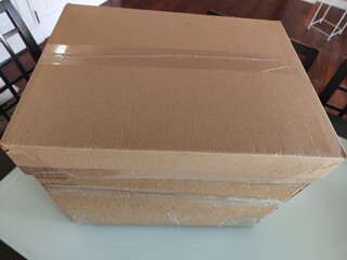 A cardboard box with tape on the top