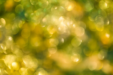 Obraz premium Blurred glowing spots create a golden bokeh effect perfect for joyful holiday and celebratory visual design