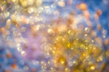 Golden festive lights produce a soft, shimmering bokeh effect with a cheerful mood and glowing brightness