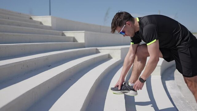 A focused athlete ties their shoelaces for a morning run amid the vibrant city energy.