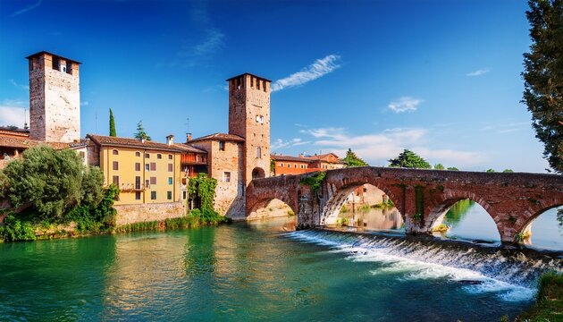 borghetto valeggio sul mincio verona italy traditional italian village with vintage colorful houses above river stone bridge and medieval gate tower among ancient architecture sunny summer day