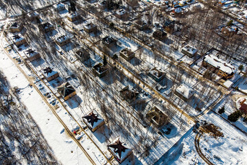 Roofs of identical low-rise buildings on a winter day, aerial view