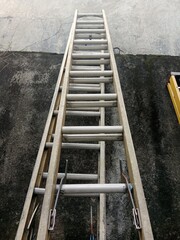 Old Iron Ladder Leaning Against Brick Wall