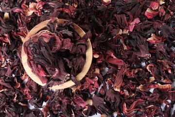 Hibiscus tea. Wooden bowl with dried roselle sepals on table, top view