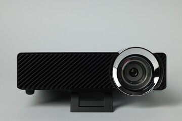 Modern video projector on light grey background, closeup