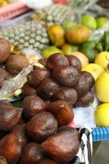 Different fresh exotic fruits at market, closeup