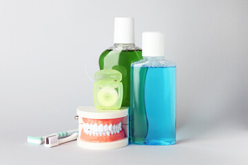 Different oral care products on light grey background