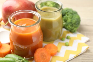 Baby food. Tasty puree in glass jars and ingredients on table, closeup. Space for text