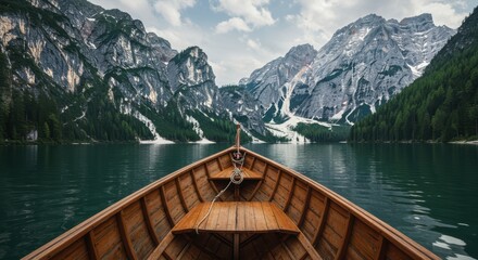 Obraz premium A Peaceful Journey on a Mountain Lake An Inspiring Boat Ride Through Nature's Majestic Scenery with Calm Water and Stunning Peaks