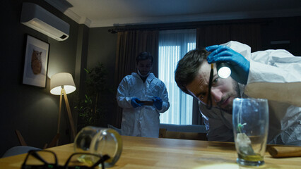 Forensic investigators analyzing evidence at crime scene