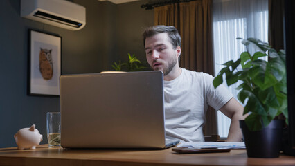 Man attending virtual meeting from home office