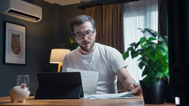 Man reviewing documents while working from home
