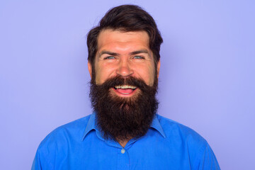 Man portrait. Smiling bearded man in stylish shirt. Fashion, clothing. Happy bearded man in trendy shirt. Successful bearded man with modern hairdo. Handsome male with beard and mustache. Barbershop.