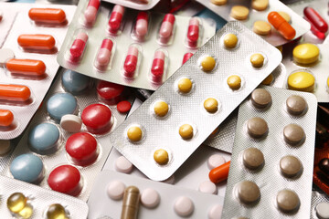 Blister packs with different pills as background