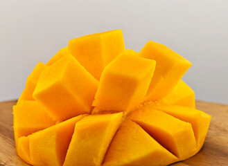 Sliced ​​mango on a wooden plate