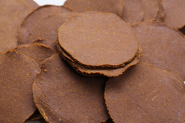 Fermented soybean discs, known as “Thua Nao,” a traditional Thai seasoning used to enhance flavor in Northern cuisine.