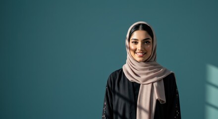 Fototapeta premium Confident Young Arab Woman in Hijab Smiling at Camera