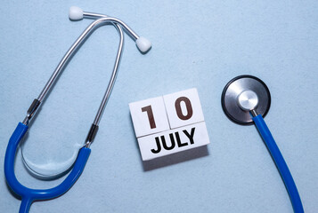 Vintage photo, July 10th. Date of 10 July on wooden cube calendar
