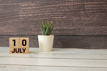 Vintage photo, July 10th. Date of 10 July on wooden cube calendar