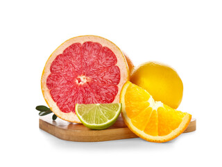 Wooden board with different cut citrus fruits and leaves on white background