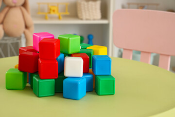 Colorful cubes on table in children's bedroom, closeup
