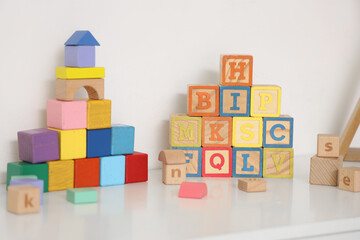 Cubes with letters on shelf in children's room, closeup