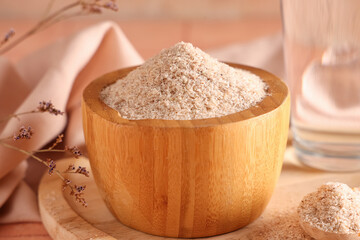 Bowl with psyllium husk powder on table, closeup