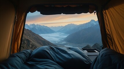 Fototapeta premium Mountain sunrise view from a rooftop tent. Inside sleeping bags