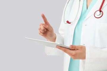 Female cardiologist with stethoscope and tablet on white background, closeup