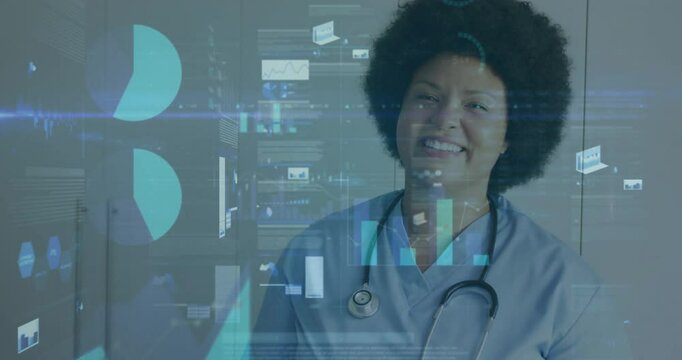 Healthcare professional smiling initiating holographic charts animating for monitoring health data