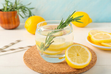 Glass of tasty lemonade and tray on white wooden table, closeup