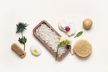 Plakat Spa composition with sea salt, massage brushes and flowers on light background