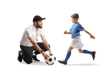 Football coach for kids with a ball and boy running