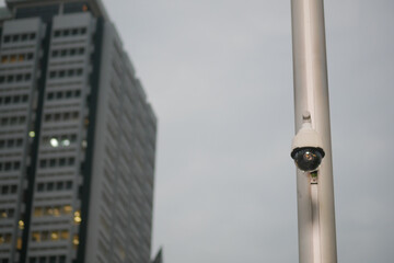 Security camera mounted on a building during sunset