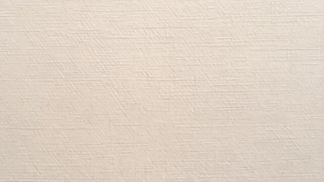 Close-up view of a beige textured paper, perfect for backgrounds and overlays in graphic design projects, stationary.