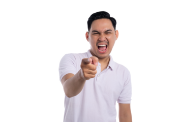 Angry young man shouting and pointing finger at camera with furious expression isolated on transparent background