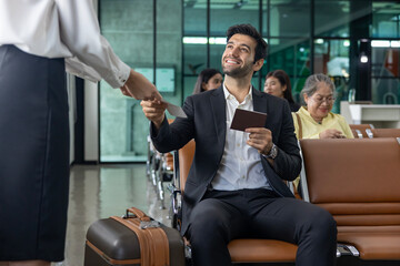 Businessman passenger is showing boarding pass to the airline ground crew at departure gate into the airplane for final inspection before boarding to plane