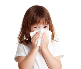 A young girl is holding a tissue to her face, possibly because she has a cold