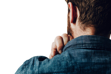 A man with a beard and a blue shirt is looking at the camera