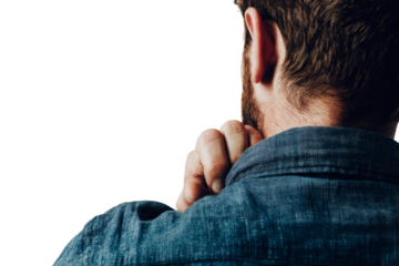 A man with a beard and a blue shirt is looking at the camera