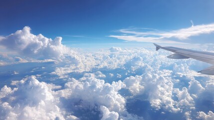 Fototapeta premium Breathtaking View from Airplane Wing Above Fluffy White Clouds