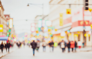 Obraz premium Blurred street scene with pedestrians and buildings in an urban environment.Premium urban photos for poster, banner and pamphlet backgrounds
