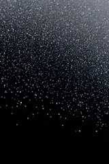 Obraz premium Abstract glittering particles falling on a dark background