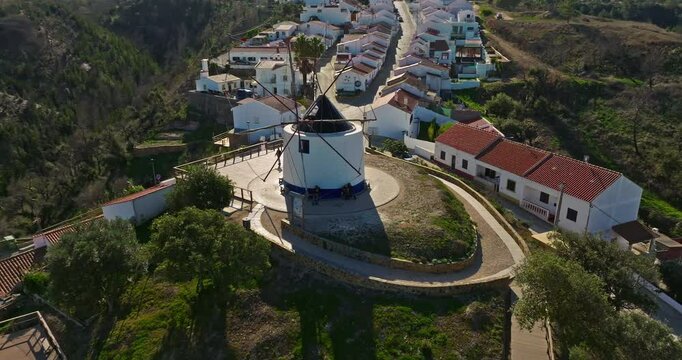 Aerial view of small village with windmill and picturesque rooftops, Odeceixe, Portugal