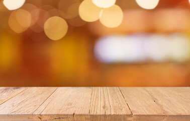 Empty wood table top and blur of restaurant background selective focus product display